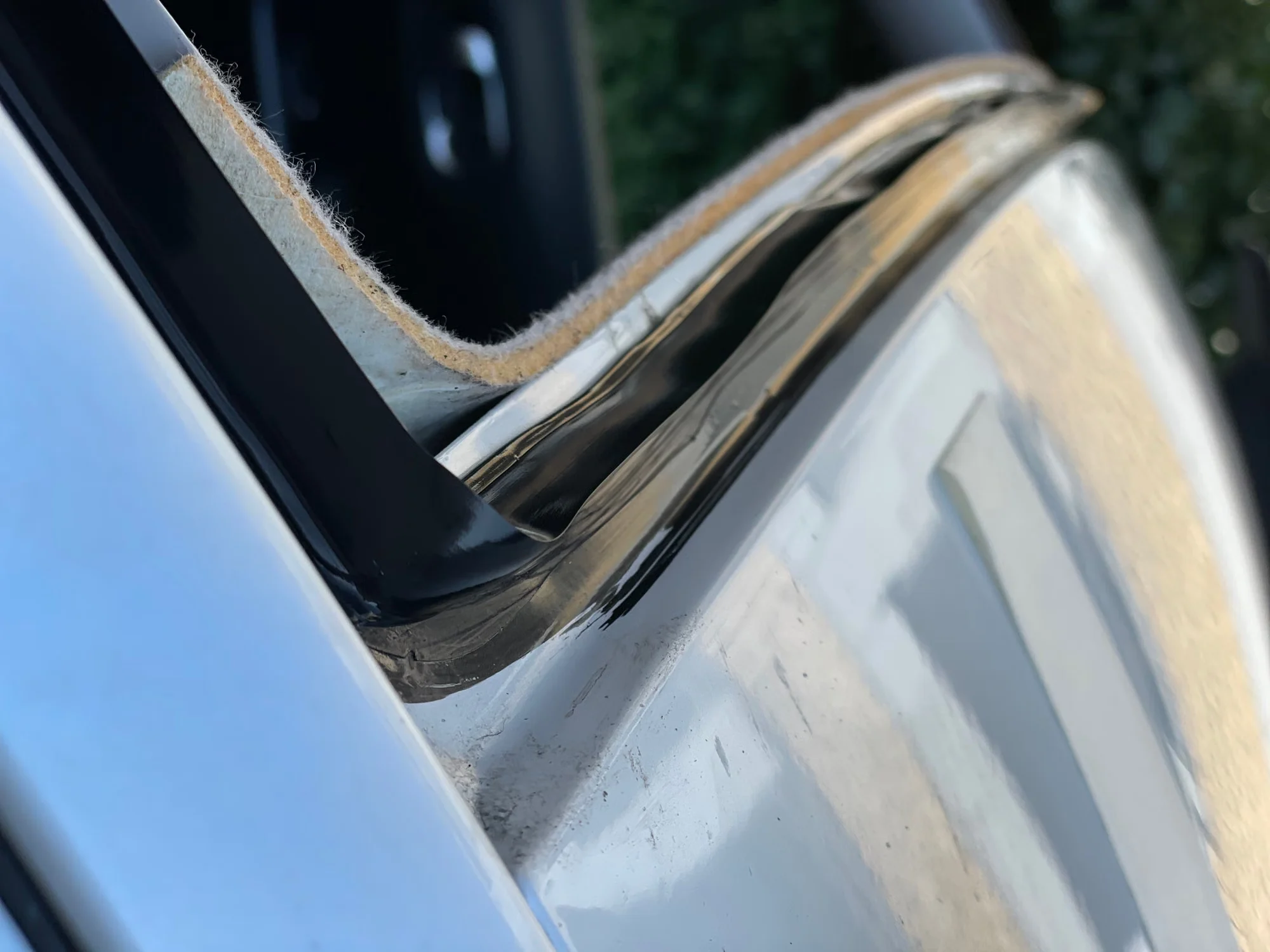 Vehicle windshield opening being prepared for replacement